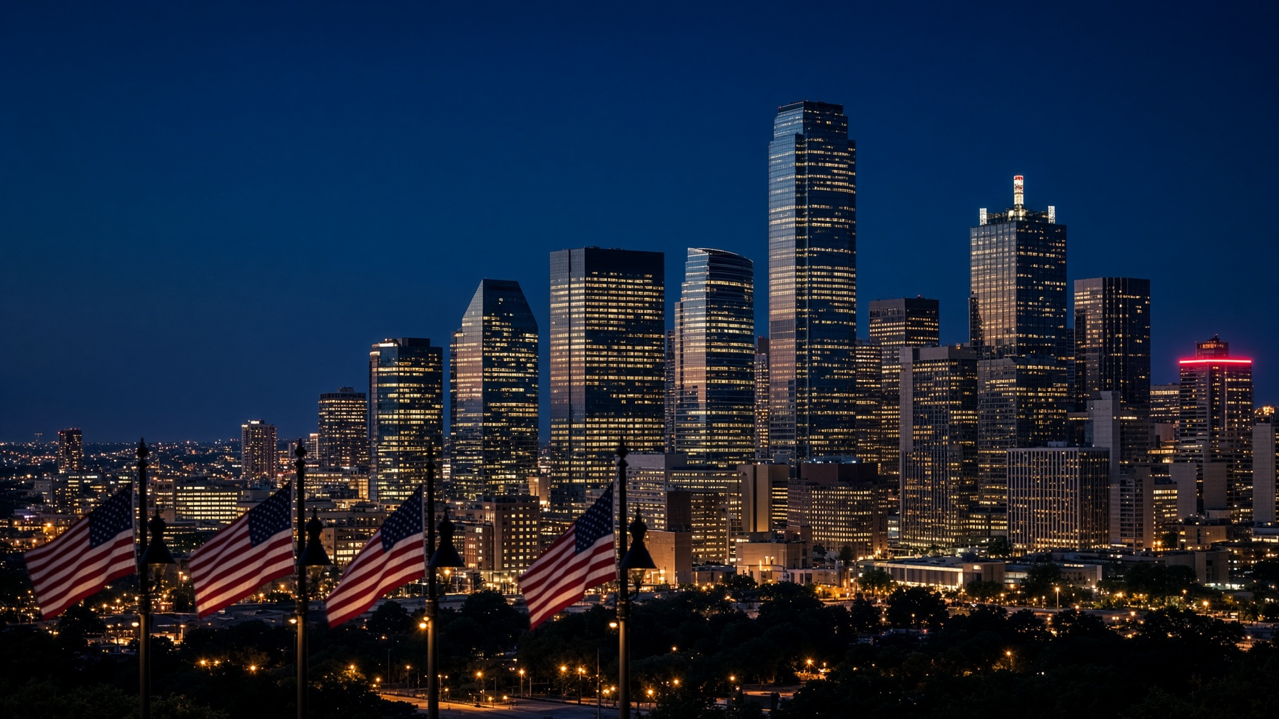 Dallas skyline at blue hour with American flags on lamp posts